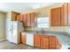 Kitchen with granite countertops, wood cabinets, and double sink at 3043 Streamlet Way, Monroe, NC 28110