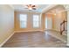 Living room features hardwood floors, neutral walls, and a view into the foyer and staircase at 3043 Streamlet Way, Monroe, NC 28110