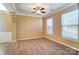 Light-filled living room with hardwood floors, neutral walls, and two windows with blinds at 3043 Streamlet Way, Monroe, NC 28110