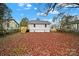 Backyard showing a gray house with a new deck, a fenced in yard, and many fallen leaves at 409 Jones S Ave, Rock Hill, SC 29730