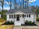 Charming renovated home with a white exterior, gray roof, and landscaped yard at 409 Jones S Ave, Rock Hill, SC 29730