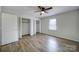 Well-lit bedroom with wood-look floors and closet at 438 Stoneycreek Ln, Rock Hill, SC 29730