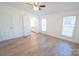 Bright bedroom with hardwood floors and access to the bathroom at 461 Ret Stafford Ln, Taylorsville, NC 28681