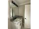 Simple bathroom with single vanity, granite countertop, and built-in mirror at 604 Impala Dr, Albemarle, NC 28001