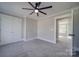 Spacious bedroom with ceiling fan and double doors to closet at 604 Impala Dr, Albemarle, NC 28001