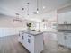 White kitchen with granite island and open concept to living room at 604 Impala Dr, Albemarle, NC 28001