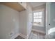 Bright laundry room with built-in shelving and window at 604 Impala Dr, Albemarle, NC 28001
