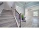 Elegant staircase with dark wood railing and grey carpet at 604 Impala Dr, Albemarle, NC 28001