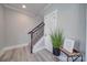 Modern staircase with dark metal railing and wood flooring at 604 Impala Dr, Albemarle, NC 28001