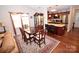 Elegant dining room with hardwood floors, a wood table, and kitchen views at 808 E Main St, Maiden, NC 28650