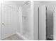 Clean bathroom with shower, storage, and tile flooring at 9321 Bayview Pkwy, Charlotte, NC 28216