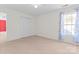 Bright bedroom with carpet flooring, double door closet, and window with curtains at 9321 Bayview Pkwy, Charlotte, NC 28216