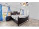 Main bedroom with wood flooring, king bed, and blue curtains at 9321 Bayview Pkwy, Charlotte, NC 28216