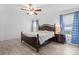 Main bedroom with wood flooring, king-size bed, and blue curtains at 9321 Bayview Pkwy, Charlotte, NC 28216