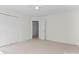 Well-lit bedroom with carpet floors and double door closet and access to hallway at 9321 Bayview Pkwy, Charlotte, NC 28216
