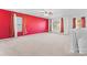 Large bonus room with red walls, carpet flooring, and multiple windows at 9321 Bayview Pkwy, Charlotte, NC 28216