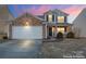 Two-story house with stone accents and a two-car garage at 9321 Bayview Pkwy, Charlotte, NC 28216