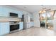 Kitchen with light blue cabinets, stainless steel appliances, and sliding glass door at 9321 Bayview Pkwy, Charlotte, NC 28216