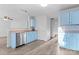 Kitchen with light blue cabinets, stainless steel appliances, and laminate flooring at 9321 Bayview Pkwy, Charlotte, NC 28216