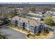 Aerial view of apartment complex surrounded by trees with a cityscape in the distance at 935 Mcalway Rd # 306, Charlotte, NC 28211