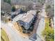 Aerial view of a stylish condo building with parking and surrounding trees in a neighborhood setting at 935 Mcalway Rd # 306, Charlotte, NC 28211