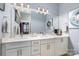 Bright bathroom features double sinks, modern lighting, and sleek white cabinetry at 935 Mcalway Rd # 306, Charlotte, NC 28211
