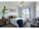 Bright bedroom with a large window, hardwood floors, light-colored walls, and a vintage sewing table nightstand at 935 Mcalway Rd # 306, Charlotte, NC 28211