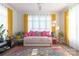 A colorful, cozy bedroom featuring vibrant textiles, plants, and a large window for plenty of natural light at 935 Mcalway Rd # 306, Charlotte, NC 28211