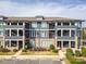 Modern condominium exterior showcasing brick accents, gray siding and staircase access at 935 Mcalway Rd # 306, Charlotte, NC 28211