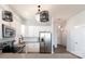 Contemporary kitchen with stainless steel appliances, stylish lighting fixtures, and a view into the hallway at 935 Mcalway Rd # 306, Charlotte, NC 28211