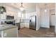 Well-lit kitchen with white cabinets, modern stainless steel appliances, and a kitchen sink with wooden floors at 935 Mcalway Rd # 306, Charlotte, NC 28211