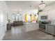 Bright, open-concept kitchen features white cabinetry, stainless steel appliances, and a large island with seating at 935 Mcalway Rd # 306, Charlotte, NC 28211
