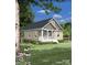 Single-story home with beige siding, a covered porch, and a landscaped yard at 0 Shaver St # 4, Salisbury, NC 28144