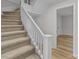 Clean carpeted staircase with white railings leading to the upper level at 1004 N Salisbury Ave, Spencer, NC 28159