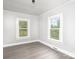 Well-lit bedroom with hardwood floors and two windows at 123 Lincoln St, Statesville, NC 28677
