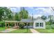 Charming white bungalow with covered carport and landscaped yard at 123 Lincoln St, Statesville, NC 28677