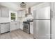 Updated kitchen with stainless steel appliances and gray cabinets at 123 Lincoln St, Statesville, NC 28677