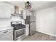 Renovated kitchen, stainless steel appliances, gray cabinets at 123 Lincoln St, Statesville, NC 28677