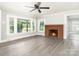 Cozy living room with brick fireplace and hardwood floors at 123 Lincoln St, Statesville, NC 28677