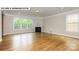 Living room featuring hardwood floors, fireplace, and corner windows at 193 Asmodean Ln, Troutman, NC 28166