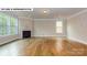Spacious living room with hardwood floors, fireplace and large windows at 193 Asmodean Ln, Troutman, NC 28166