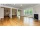 Open living room with hardwood floors, fireplace, and kitchen views at 193 Asmodean Ln, Troutman, NC 28166