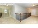 Elegant upper hallway with iron railings and neutral carpeting at 193 Asmodean Ln, Troutman, NC 28166