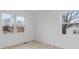 Spacious bedroom with light wood floors and two windows at 1940 33Rd Ne Ave, Hickory, NC 28601
