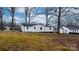 Back of house showing a large backyard with mature trees at 1940 33Rd Ne Ave, Hickory, NC 28601