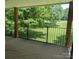 An outdoor porch features a black metal railing with a view of lush green space at 1985 Lancer Ct, Gastonia, NC 28054