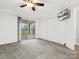 Bright bedroom features a ceiling fan, built in closet, and sliding doors with access to the covered balcony at 1985 Lancer Ct, Gastonia, NC 28054