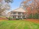 A two-story building has multiple back patios and mature landscaping on a green lawn in autumn at 1985 Lancer Ct, Gastonia, NC 28054
