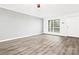 Bright living room with gray walls, wood-look floors, and large window at 1985 Lancer Ct, Gastonia, NC 28054