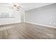 Spacious living room with gray walls, wood-look floors, and ceiling fan at 1985 Lancer Ct, Gastonia, NC 28054